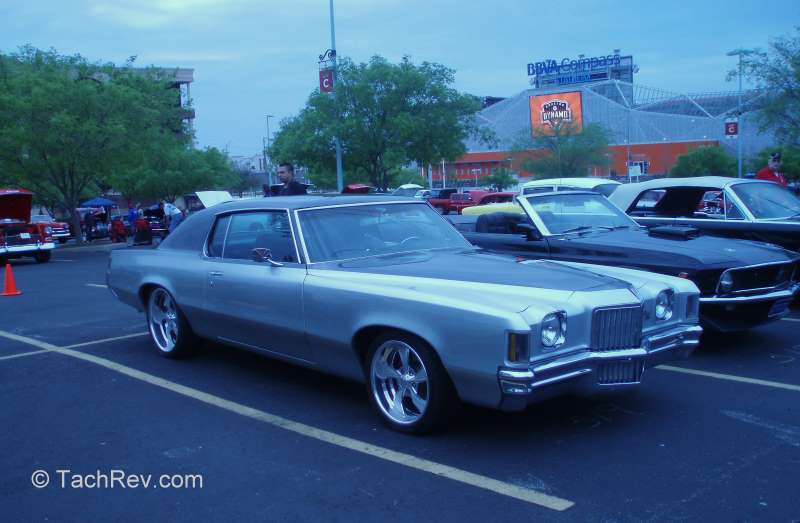 1969 Pontiac Grand Prix restomod with background of the Houston Dynamo/BBVA Compass Bank soccer stadium.
