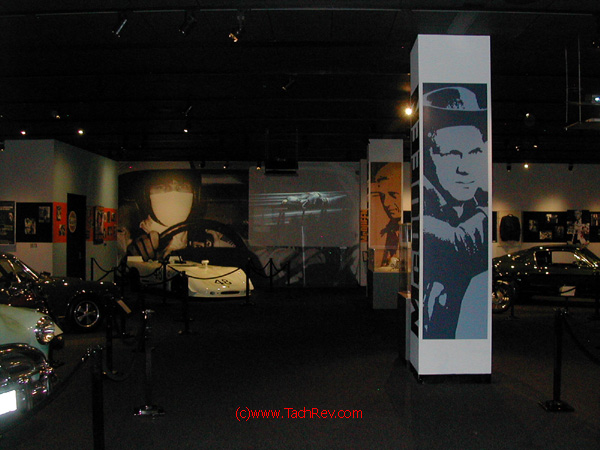 My entrance into the Steve McQueen exhibit garnered this eye candy: Steve driving in the Movie Le Mans on the back wall with his racecar below, the Mustang from the movie BULLET, other cars he owned and the many movie images of Steve McQueen.