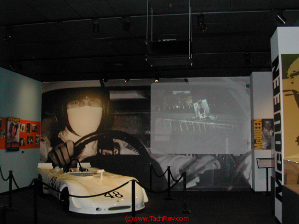 On the screen the movie Le Mans - with Steve actually driving one of a pair of GULF sponsored Porsches in the Movie, the beginning of his scripted crash.