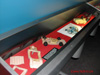 Although a blurry shot, I still included this image for the view of the vehicle patterns. This information tag reads: "In a later refinement to the wood pattern technique, epoxy shells were cast from the wooden carving. These epoxy shells included all of the parts of the finished toy, with all of their correct wall thickness, at 4:1 scale. The steel mold was still machined with a pantograph mill."