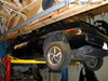 Early model Fiero on lift getting some TLC service